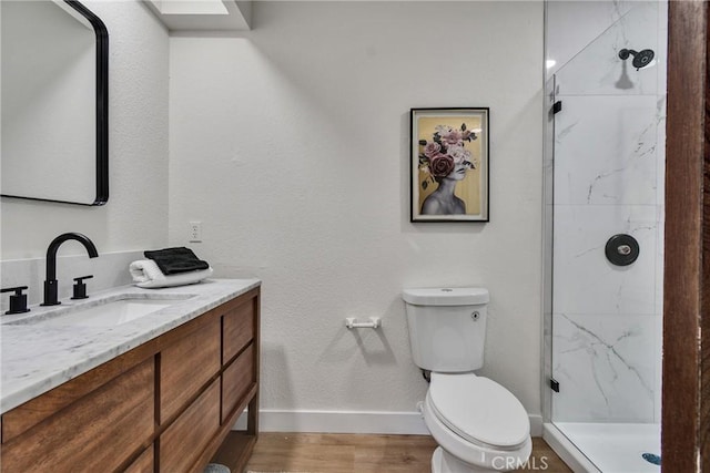 bathroom featuring toilet, vanity, hardwood / wood-style flooring, and walk in shower