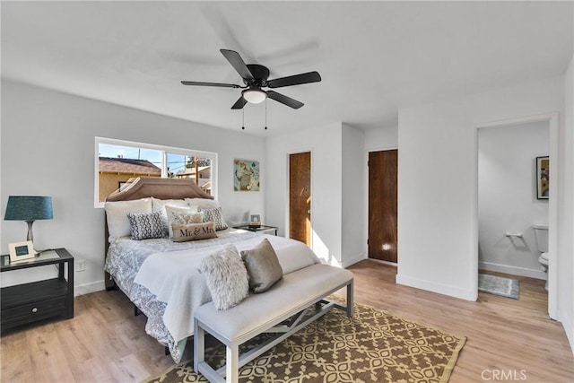 bedroom with ceiling fan, ensuite bath, and wood-type flooring