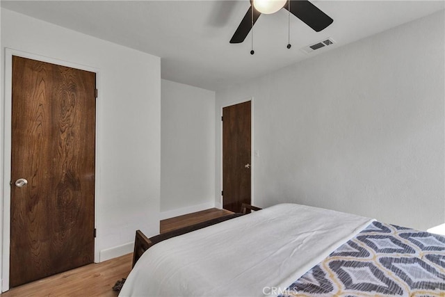 bedroom featuring ceiling fan, a closet, and hardwood / wood-style floors