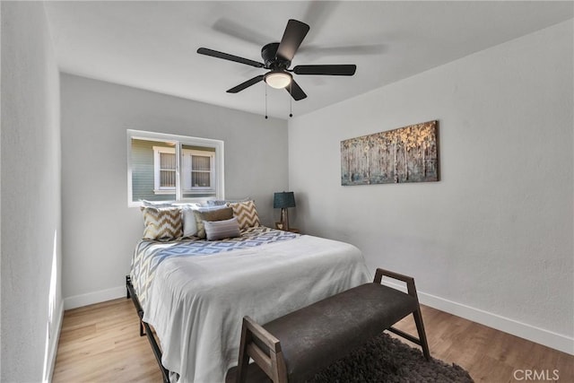 bedroom with ceiling fan and light hardwood / wood-style floors