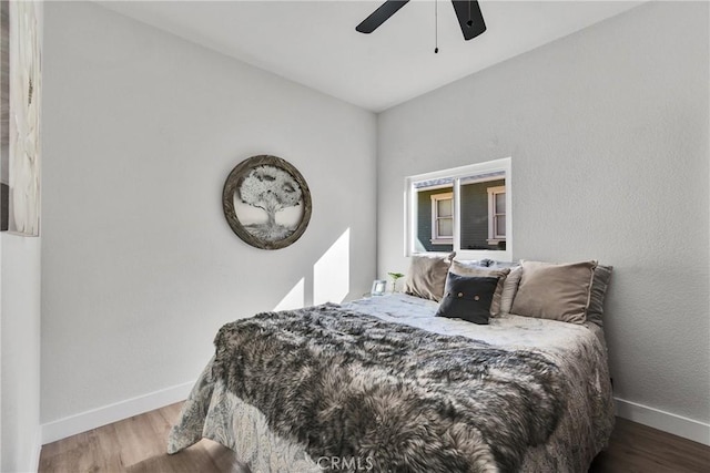 bedroom with ceiling fan and hardwood / wood-style floors