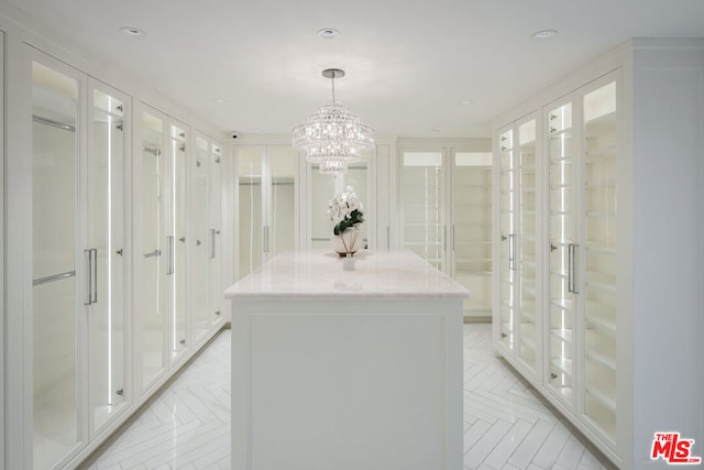 spacious closet featuring an inviting chandelier