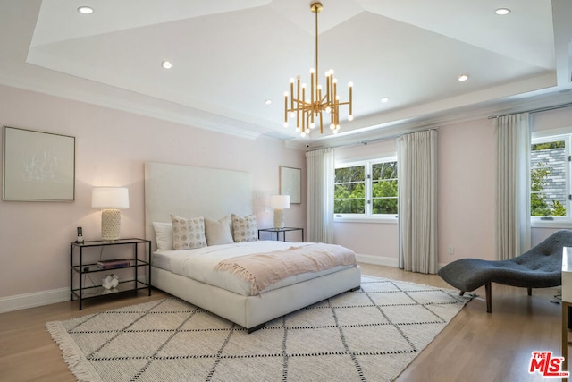 bedroom featuring light hardwood / wood-style floors and a notable chandelier