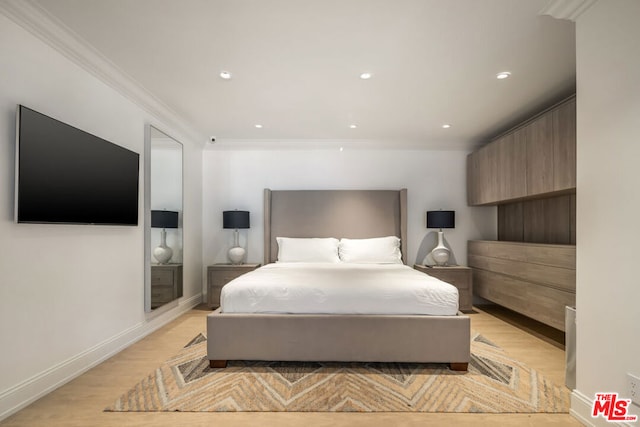 bedroom with light hardwood / wood-style floors and ornamental molding