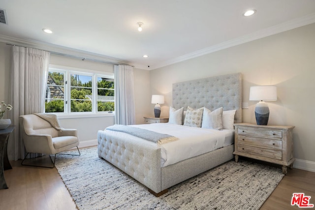 bedroom featuring crown molding and hardwood / wood-style flooring