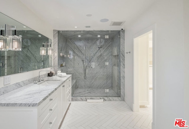 bathroom with a shower with door and vanity