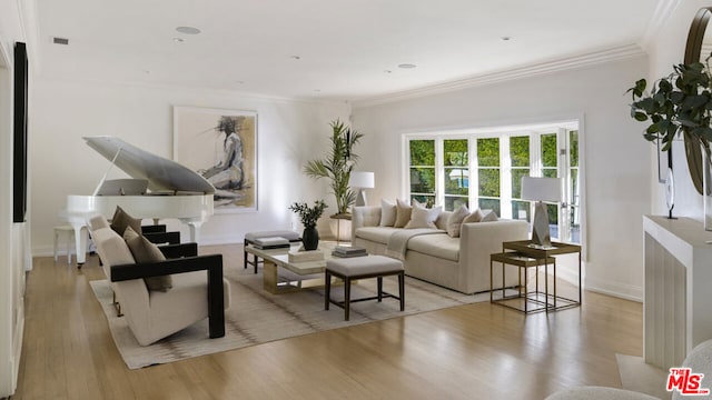 living room featuring crown molding and light hardwood / wood-style flooring