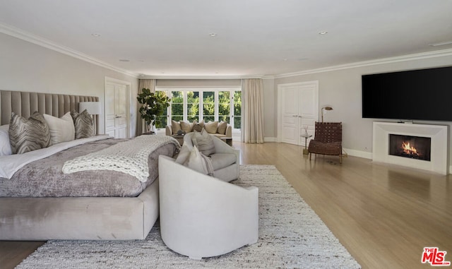 bedroom featuring wood-type flooring and ornamental molding