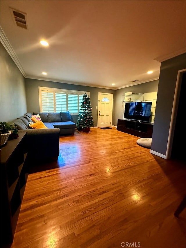 living room featuring crown molding and wood-type flooring