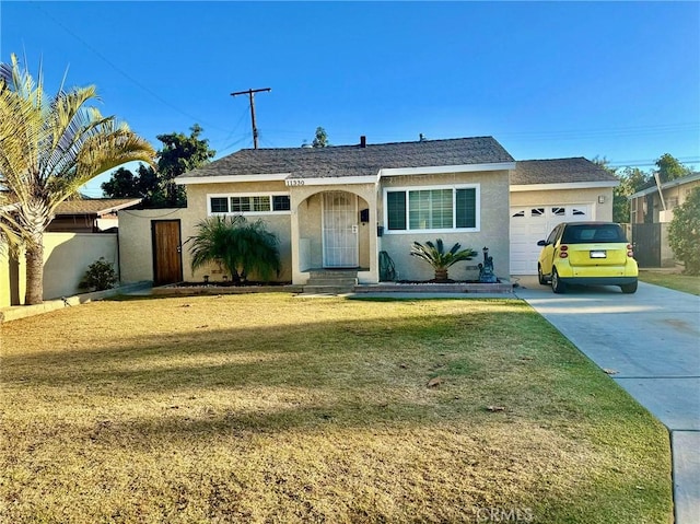 ranch-style house featuring a front yard and a garage