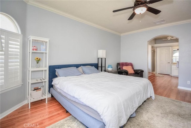 bedroom featuring ceiling fan, wood-type flooring, and crown molding