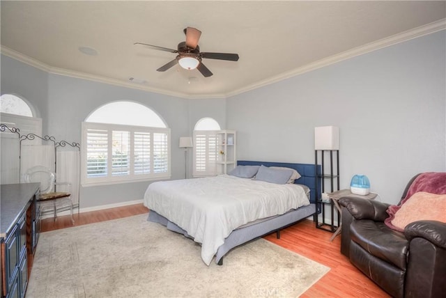 bedroom featuring ceiling fan, crown molding, and hardwood / wood-style flooring