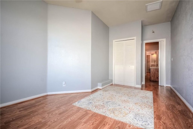 unfurnished bedroom featuring a closet and wood-type flooring