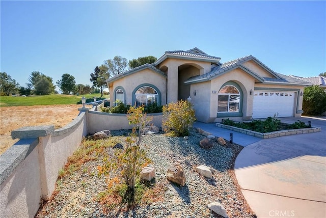 mediterranean / spanish-style home with a garage