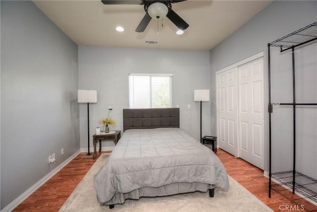 bedroom featuring hardwood / wood-style floors, a closet, and ceiling fan