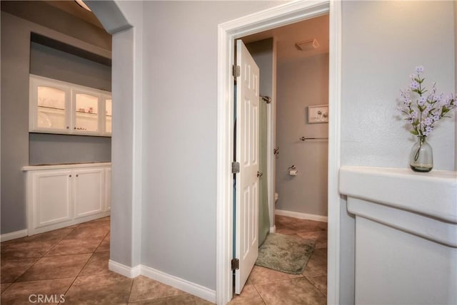 hall with light tile patterned floors