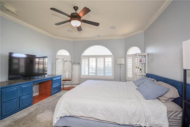 carpeted bedroom with ceiling fan and crown molding