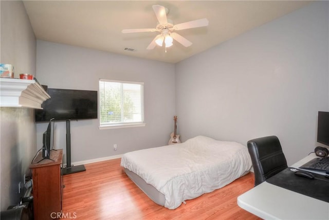 bedroom with hardwood / wood-style flooring and ceiling fan