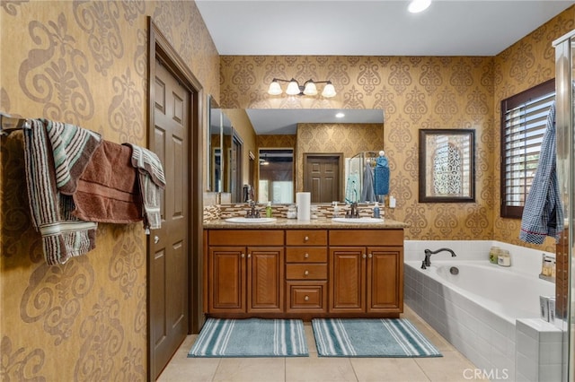 bathroom with vanity, tile patterned floors, and tiled tub