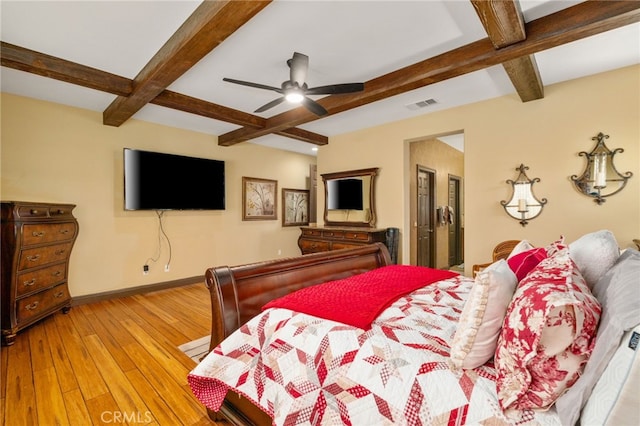 bedroom with beam ceiling, ceiling fan, and light hardwood / wood-style flooring