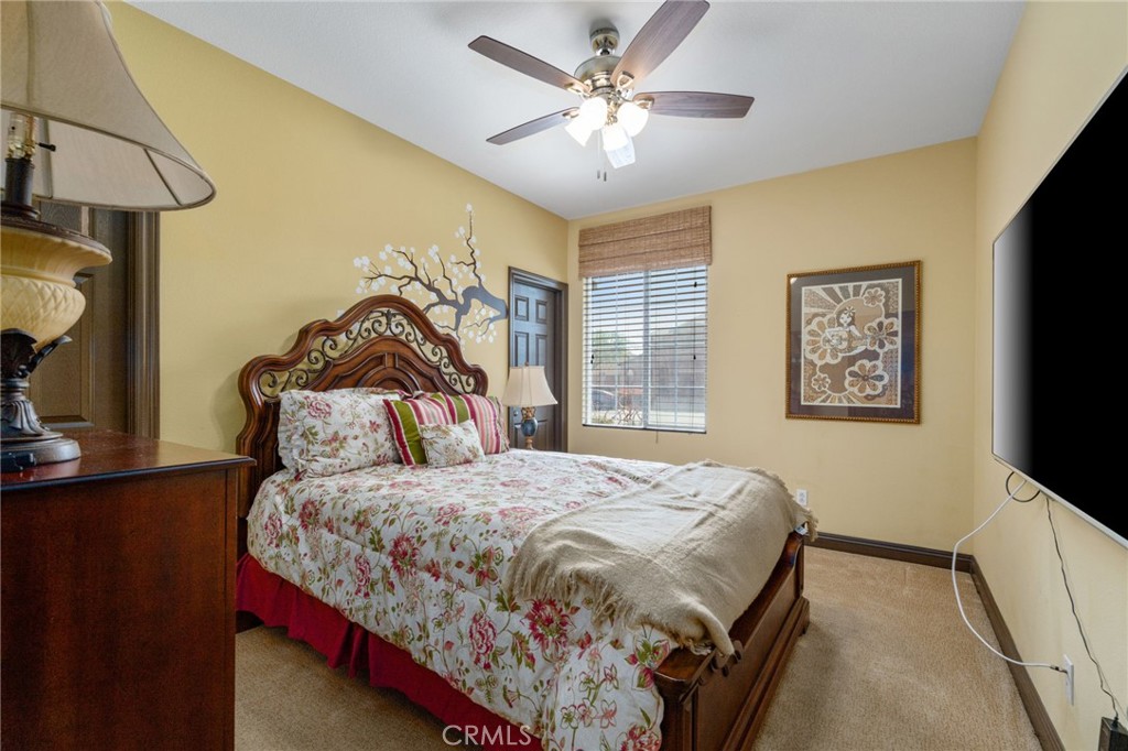 carpeted bedroom featuring ceiling fan