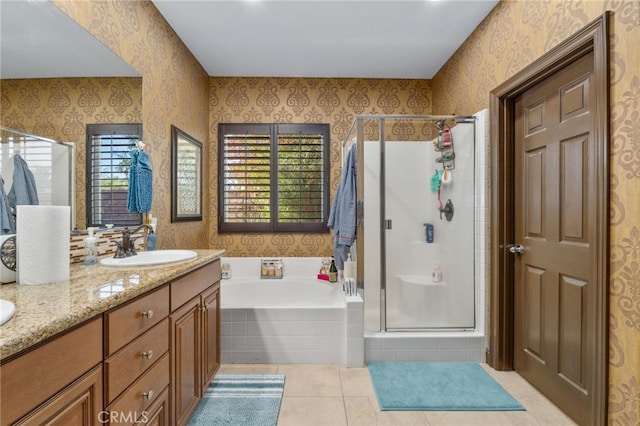 bathroom featuring tile patterned flooring, vanity, and separate shower and tub