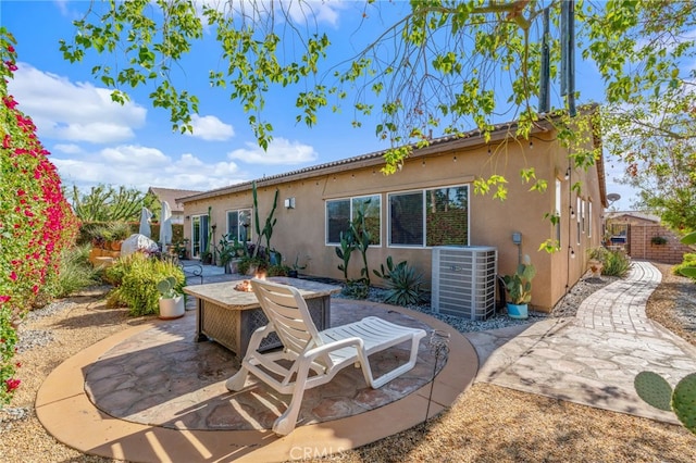 back of house with central AC and a patio