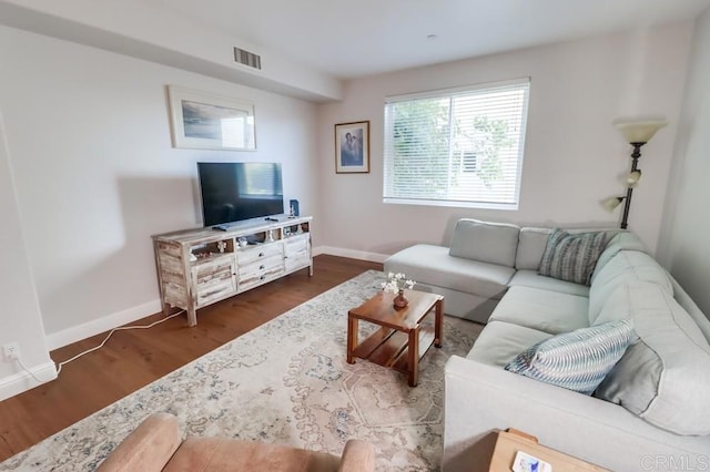 living room featuring dark wood-type flooring