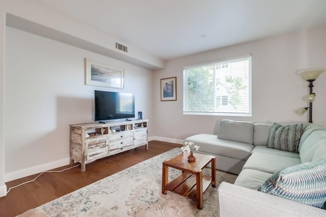 living room with dark hardwood / wood-style flooring