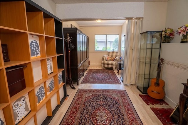 corridor with light hardwood / wood-style flooring