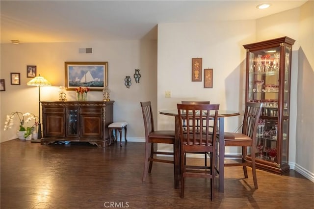 dining space featuring dark hardwood / wood-style flooring