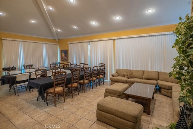 living room with light tile patterned floors and vaulted ceiling with beams