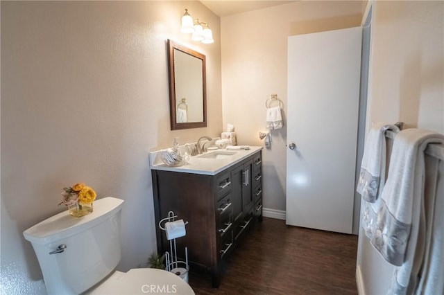 bathroom with vanity, hardwood / wood-style flooring, and toilet