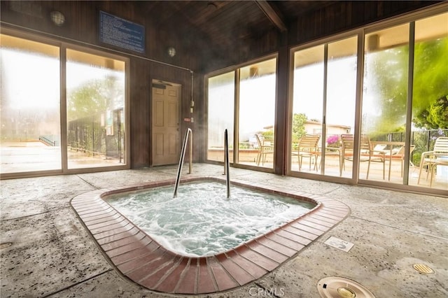 sunroom with a jacuzzi