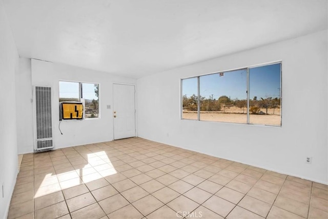 empty room featuring plenty of natural light and light tile patterned flooring