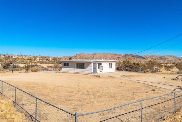 rear view of house with a mountain view and a rural view