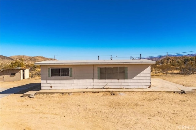 back of property with a mountain view