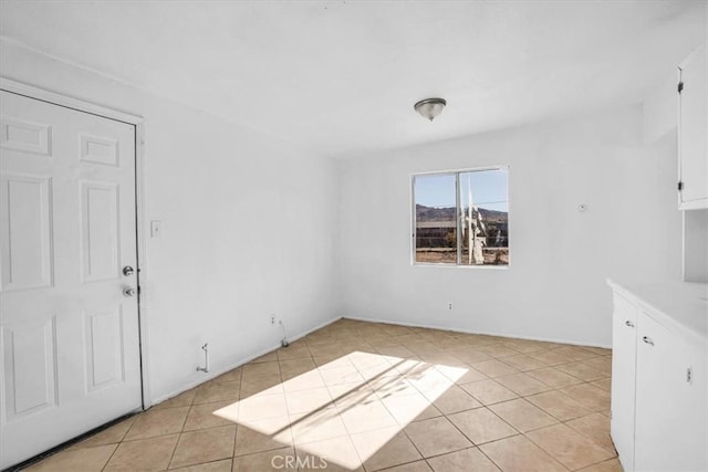 empty room with light tile patterned flooring