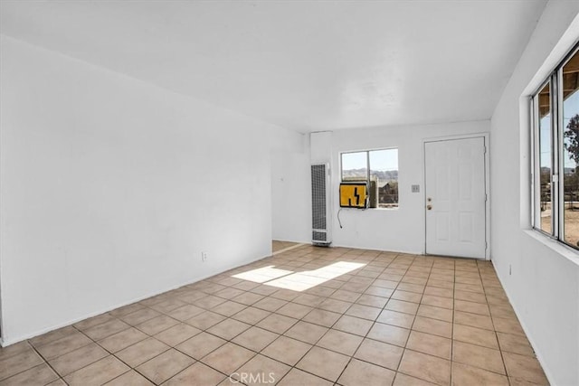 tiled empty room with a wealth of natural light