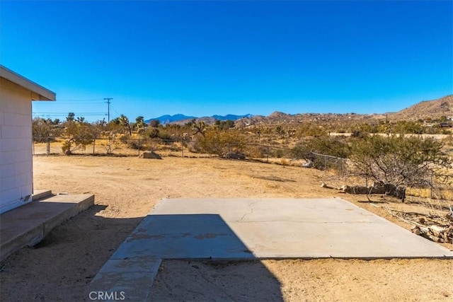 view of yard with a mountain view and a patio