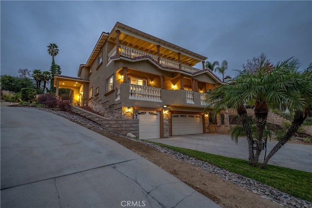 view of front of home with a garage and a balcony