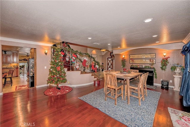 dining area with dark hardwood / wood-style floors and ornamental molding