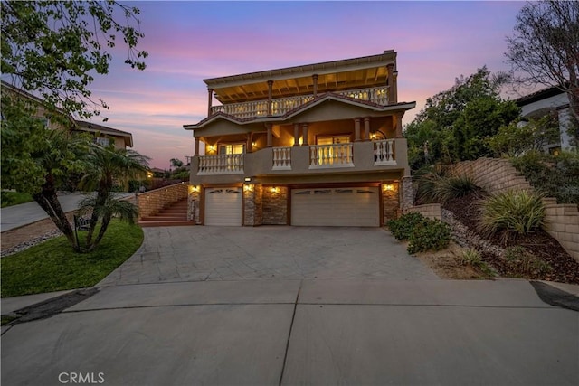 view of front of home with a balcony and a garage