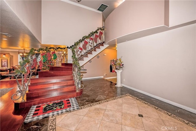 stairway featuring a high ceiling