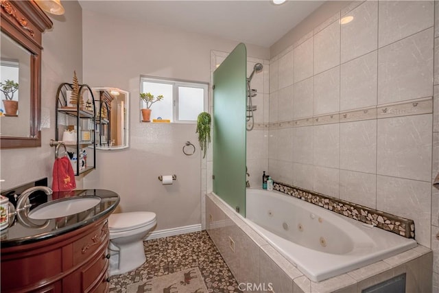 full bathroom featuring tile patterned flooring, toilet, vanity, and tiled shower / bath