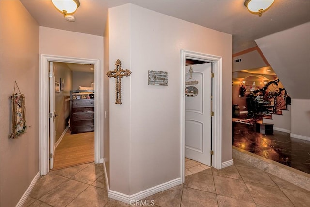 corridor with light tile patterned flooring