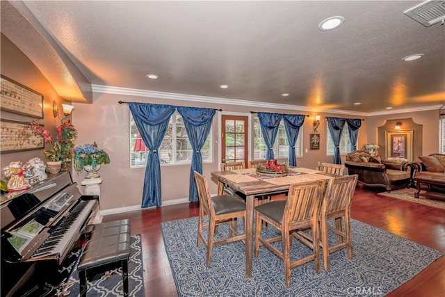 dining space featuring dark wood-type flooring and ornamental molding