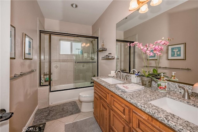 full bathroom with tile patterned floors, shower / bath combination with glass door, vanity, and toilet