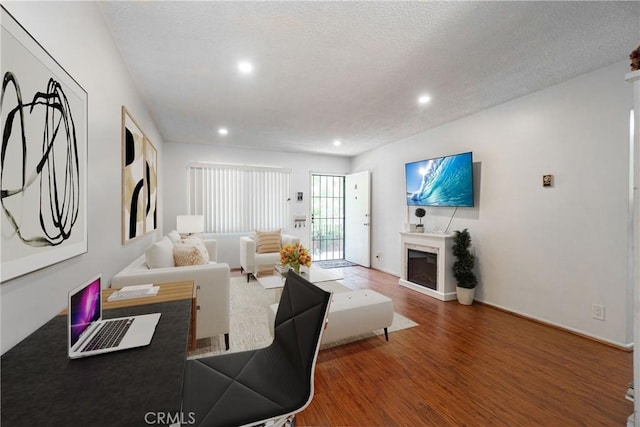 living room featuring hardwood / wood-style floors and a textured ceiling