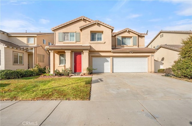 view of front of house featuring a garage and a front lawn